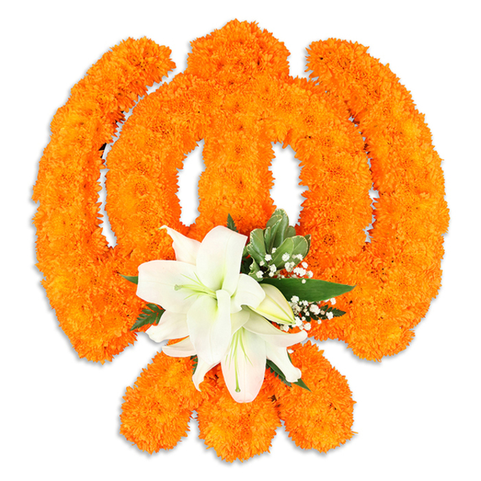 A reverent floral Ik Onkar is portrayed here, shaped from an abundance of tightly placed bright orange marigold heads that form the numeral-one curve, the small crescent-like extension and the characteristic dot with clear, confident lines against a pristine white background. The warm, celebratory orange of the marigolds has been packed densely to produce a textured, almost sculpted surface that reads as both tactile and luminous, catching the light to emphasise its three-dimensional form. At the lower centre of the design a small, deliberate accent of pure white lilies softens the composition: several broad, open lily blossoms display gently cupped petals with pale green-and-yellow stamens, while smaller buds nestle close and glossy green leaves tuck in around their base. Tiny white filler flowers lift the edges and provide a whisper of softness between the orange mass and the lilies' cool clarity. A subtle drop shadow beneath the arrangement suggests it is freestanding on a platform or tray, crafted to be placed reverently in a home shrine, temple vestibule, or at a community gathering. The arrangement evokes devotion and unity-the literal meaning of Ik Onkar-blending traditional floral materials with careful artisan technique. I picture this piece offered during Guru Nanak Jayanti or Vaisakhi at a local community hall near Bell Common or arranged thoughtfully for a ceremony on Epping High Street, its scent and texture meant to comfort and centre those who stand before it.