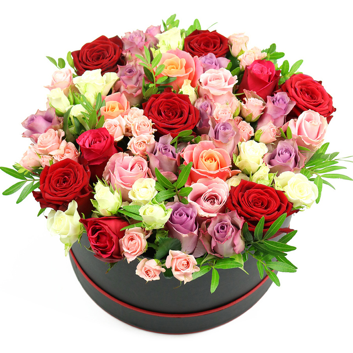 Presented against a pristine white background, this opulent rose hat box arrangement seems to float, every detail clearly defined, as though you were standing at a florist's counter in Epping, running your fingers just above the blooms. The container is a stylish black cylindrical hat box with a subtle red trim around the base, a small but striking detail that frames the flowers like a piece of fine jewellery. From this base rises a generous, domed mass of roses, tightly arranged so that petals touch petals, creating a rich, tapestry-like surface. Deep crimson and scarlet roses dominate in places, the colour of classic romance and evening celebrations. Around them, romantic fuchsia and gentle blush pink roses mingle with warm coral and soft peach tones, adding layers of warmth and tenderness. Pockets of creamy white and ivory blooms brighten the design, accenting the deeper shades, while refined lavender and muted purple roses add a sophisticated, modern nuance. There is a deliberate mix of fully opened, multi-petalled roses that showcase intricate petal spirals, alongside half-open buds and smaller spray roses that create a sense of depth and life, as though the bouquet is still unfolding. Slender stems of green foliage, possibly ruscus or lightly textured filler greenery, peek out between the blossoms, their fresh green tones echoing the leafy streets and garden fronts found around Epping's residential lanes. The bouquet's rounded silhouette is meticulously balanced, with no gaps or visual heaviness, just a smooth, luxuriant curve of colour. This design feels perfectly suited for grand gestures-anniversaries, significant birthdays, or a heartfelt thank-you-ready to be enjoyed in homes and venues across Epping, where its fragrance and colour would instantly command attention.