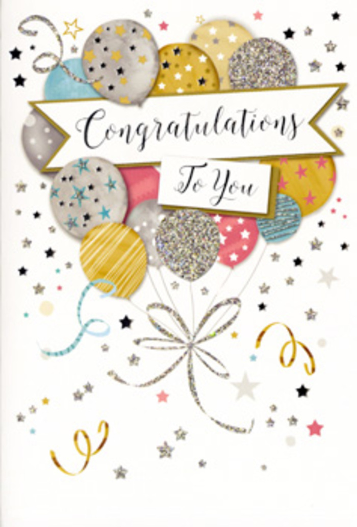 This photograph presents a tall congratulations card propped neatly as if ready to accompany a fresh bouquet from a local Epping florist. The artwork on the front is a carefully composed cluster of balloons that gives the impression of floating upward, as though released above the rooftops around Epping Station on a crisp, clear evening. The balloons are rendered in a refined palette: warm gold, soft champagne, brushed silver, gentle sky blue, tender blush pink and muted grey. Each one is subtly distinct; some are shaded smoothly to suggest a glossy surface catching the light, while others are decorated with fine metallic stars, glitter-like speckles, or narrow bands of shining stripes. Slender ribbons in intertwining lines of gold and silver tumble from the base of the cluster, curling and looping with a free, celebratory energy, much like streamers left behind after a party at a favourite local venue. A graceful banner stretches across the centre of the design, gently touching several of the balloons, and bears the words Congratulations To You in an elegant, sweeping script that feels both modern and timeless. Around this focal point, small stars, dots and swirling confetti motifs scatter across a creamy, almost glowing background, giving a sense of gentle movement and sparkling air, as if the card itself is filled with tiny bursts of joy. The overall feeling is one of polished celebration and heartfelt pride-perfect for marking a promotion, a graduation from a nearby school, or any cherished milestone in the Epping community. It's the kind of card you can imagine standing beside a vase of fresh flowers, quietly amplifying the happiness in the room.