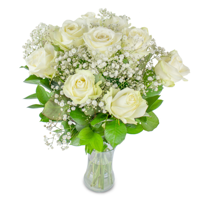 A composed bouquet of about twelve creamy-white roses, gently accented with fine clusters of baby's breath, rests in a plain glass vase against a spotless white field, each element chosen to convey calm and refinement. The roses vary in openness-some hold a classic cupped form while others spill open into soft, layered petals-producing a sense of natural movement and the intimate progression of bloom. Baby's breath threads through the arrangement like a veil, its multitudinous petite florets forming a delicate, starlit texture that softens edges and introduces a feeling of lightness. The supporting greenery is rich and varied, from deep emerald leaves that ground the bouquet to paler lime-green shoots that give lift and contrast; their subtle sheen and veining bring depth against the pale blossoms. The clear glass vase shows the clean, trimmed stems and water line, a small visual reassurance of freshness and meticulous florist technique. Bathed in diffused, ambient light-the kind that might shimmer under the trees of Epping Forest or in a sunlit window on Epping High Street-the petals appear almost translucent, and the scent is a modest whisper of fresh cut flowers rather than an overpowering perfume. As a local florist arranging pieces for town-centre ceremonies, memorials at the parish church, or intimate home deliveries, I favour this timeless palette for its versatility and gentle dignity. It offers a tender, sincere message of love, remembrance, or quiet congratulations to be shared across Epping and nearby hamlets.