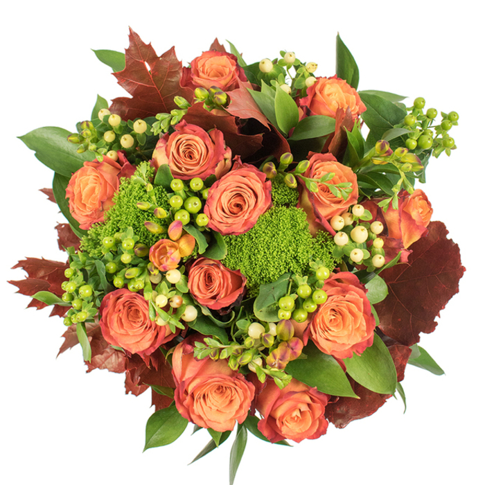 Captured in a top-down composition on a stark white surface, this richly textured arrangement reads as an intimate autumn tableau. The focal point is a generous cluster of fully opened roses whose petals shift from a tender peach at their centers to coral and then to deeper orange and russet-edged tips, producing a soft ombré that mirrors the changing canopy of trees around Epping High Street in mid-autumn. Between these classic blooms, small clusters of Hypericum berries provide contrast: some are a vivid lime-green that brightens the bouquet, others a creamy pale yellow that calms the intensity. Interwoven amid the roses are compact, velvety mounds of green trick dianthus (or similar textured filler), their moss-like appearance lending a surprising, tactile softness that invites touch. Lush fresh greenery with broad, shiny leaves forms a verdant backdrop and frames the arrangement, while larger, lobed leaves in deep burgundy and burnished brown are set throughout to emphasize the seasonal theme. The arrangement is tightly grouped and circular, designed to sit as a table centerpiece where its layered textures and warm hues can be appreciated from all sides. Under soft studio light the bouquet's surfaces pick up a gentle sheen and cast delicate shadows, adding depth without stealing the warmth of the colours. Ideal for autumn celebrations or as a thoughtful seasonal gift after a stroll through Bell Common or Epping Forest, this bouquet conveys comfort, gratitude, and the rich textures of the harvest season.