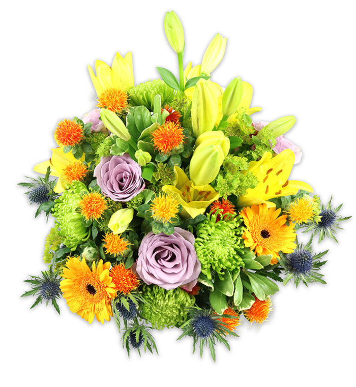 A richly coloured, densely arranged bouquet set against a stark white background, offering a lesson in contrast and texture for the attentive viewer. The composition is led by radiant yellow Asiatic lilies - some revealed fully with speckled throats and prominent stamens, others retained as elegant, upward-reaching buds that convey anticipation and height. Two or three soft lavender roses occupy a central, calming position; their layered, spiralling petals introduce a romantic, classic note that balances the bolder elements. Bright orange Gerbera daisies with darker centres are distributed to create visual stops of warmth, while lime-green button chrysanthemums produce voluminous, ruffled masses that feel tactile and almost cushiony. Interspersed, small, spherical orange and golden-yellow button-like blooms add playful texture and rhythm, and several blue-grey sea thistles (likely Eryngium) emerge from the lower planes with star-like bracts that cut a cool, structural silhouette against the otherwise sunlit tones. The foliage, varied in scale and sheen, frames the bouquet and gives it a garden-fresh depth. The lighting is soft and even, accentuating petal translucence and the subtle interplay of matte and glossy leaf surfaces. This arrangement reads as both joyful and considered - suitable for seasonal celebrations, a bright hospital room, or as a striking table centre after an afternoon at Epping Market or a walk beneath the trees of Epping Forest - where its palette would echo late-spring warmth and local greenery.