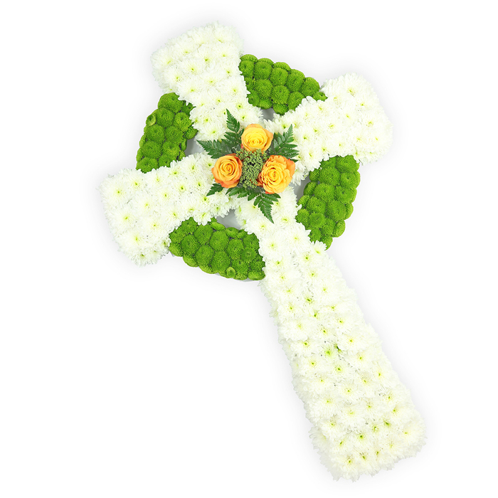 This image shows a three-dimensional Celtic cross sculpted from fresh flowers, presented on a bright white background and seen from a slight overhead perspective so the form reads in full. The body of the cross is densely covered in tiny, pure white spray chrysanthemums that create a soft, clouded texture across the arms and the elongated lower stem. Briskly contrasting those white masses are sections of bright, almost lime-green button chrysanthemums; the green buttons are deployed to define the circular boss at the centre where the arms meet and to alternate through the arm segments, producing a plush, knot-like effect that recalls traditional Celtic design. Centered in the round intersection is a small cluster of three vivid orange-yellow roses - their warm, sunflower-tinged petals provide a tender, glowing focal point against the cool white and vivid green, and are gently set off by darker green fern or foliage sprigs that add depth and a natural frame. The clean lighting sharpens petal detail and the three-dimensional layers of flowers while maintaining a restrained, reverent mood. This arrangement reads especially well for memorials that honour Irish roots - the white, green and orange palette subtly referencing the Tricolour - and would be chosen for a funeral service in the Epping area, perhaps to be placed near the altar of a parish church or at a graveside beneath the tall trees of Epping Forest, offering a composed expression of respect and memory.