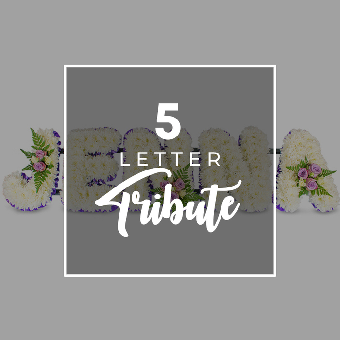 A carefully lit product-style photograph showcases a personalised five-letter funeral flower tribute, the sort of bespoke design often chosen by families across Epping to spell out a loved one's name. Set against a clean, light grey background, the floral letters are arranged horizontally, substantial in size and crafted to stand proudly at a service. Each letter is completely covered in tightly massed white chrysanthemums, their small, rounded petals overlapping to form a dense, plush surface reminiscent of soft snow or a downy cushion. The visible sequence suggests the name JOHN with an additional A to the right, hinting at how the tribute can be customised to any meaningful five-letter word. A narrow border of deep purple satin ribbon runs around the edge of every letter, its rich colour lending structure, definition, and a quiet sense of formality to the tribute. At intervals, delicate groupings of flowers soften the composition: clusters of pale pink and lilac-toned spray roses nestle into the white base, accompanied by light, airy ferns and sprigs of fresh greenery. These accents bring gentle colour and movement, much like the soft shades found in the gardens and green spaces around Epping High Street in spring. Over the central section of the arrangement sits a translucent grey square, edged in white, that partially obscures the letters beneath. On this overlay, the words 5 LETTER appear in crisp, white, sans-serif capitals above the word Tribute in a flowing script. The overall impression is one of dignity, calm, and personal remembrance, a floral lettering piece created with care to accompany a final farewell.