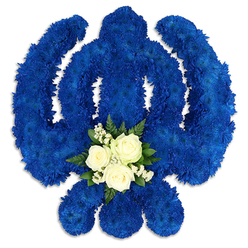 Set against a spotless white background, this impressive Sikh Khanda floral tribute commands attention with its deep royal blue petals and clear, symbolic form. The central sword, encircling chakkar, and two outward-arching kirpans are all shaped from densely packed chrysanthemum-type flowers, each bloom pressed close to the next until the surface looks almost like soft blue velvet. The colour is intense yet soothing, evoking the quiet depth of the sky seen from the edge of Epping Forest just before dusk. At the lower point of the central circular section, a contrasting cluster of white flowers rests like a calm heartbeat in the middle of the design. Three elegant white roses, their petals gently opening, are surrounded by tiny white filler flowers and a halo of rich, dark green leaves, which may be fern or salal. This smaller bouquet within the emblem brings a sense of purity, tenderness, and personal love to the strong, unwavering lines of the Khanda. Gentle shadows fall beneath the petals and blades, hinting that the tribute is raised slightly from the surface, giving it sculptural presence, as if it is ready to be placed beside a casket or on a stand during a Sikh funeral or memorial. The overall mood is one of quiet devotion and carefully expressed respect, the kind of bespoke piece a family in Epping might select to honour a relative's faith, ensuring that their spiritual identity is lovingly represented during a final farewell.