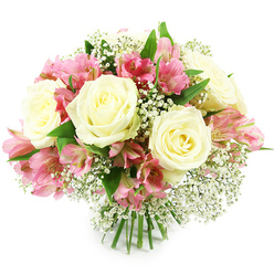 A rounded, hand-tied bouquet filled with creamy white roses, vivid pink alstroemeria, and airy sprigs of white baby's breath is set against a clean white studio background, giving the arrangement a calm and timeless feel. Several large roses form the visual anchor, their petals unfolding in soft spirals that create pools of light and shadow, with the centers tinged in the faintest hint of buttery cream. Threaded between them, pink alstroemeria blossoms bring movement and brightness; each narrow petal curves outward, coloured in shades from soft rose-pink to lively fuchsia, subtly brushed with darker streaks that draw the eye inward. Fine clusters of gypsophila, like tiny white stars perched on slender stems, nestle among the larger blooms, filling any gaps and lending the bouquet an ethereal, almost cloud-like texture. Dark and mid-green foliage forms a discreet collar at the base of the flowers, offering contrast and a sense of garden freshness familiar to anyone strolling past cottage gardens around Epping or along Bell Common. The stems are bound neatly at the bottom, their polished green lengths aligned with care, emphasizing that this is a thoughtfully hand-crafted design ready to slip into a favourite vase or be carried as a gift. The lighting is bright and even, catching the gentle sheen of each petal and making the white tones appear crisp yet warm. Visually, the bouquet communicates tenderness and quiet joy, suited to celebrations such as birthdays, engagements, or new beginnings, as well as simple gestures of appreciation delivered to homes, offices, or cosy cafés throughout the Epping area.