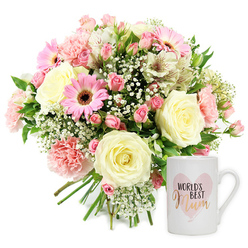 Set against a bright, uncluttered white background, this image captures a thoughtful floral gift set that seems ready to be delivered to a family home around Epping High Road or a cosy cottage near Theydon Bois. On the left, a generously rounded bouquet is hand-tied, its stems gathered neatly and left visible, giving a natural, freshly picked feel. The colour palette is gentle and feminine: creamy whites, blush pinks, and soft rose tones, offset by vivid green foliage. At the centre, large cream roses unfurl in full, spiralled layers, their petals thick and plush. Scattered among them, ruffled pink carnations and clusters of dusky spray roses add subtle depth. Bright pink gerbera daisies, each with a distinct dark centre, bring a joyful, contemporary note, like little suns glowing among clouds. Airy white baby's breath fills the spaces between, creating a misty, romantic haze, while slender white alstroemeria, delicately streaked with reddish-brown markings, arc gracefully throughout the design. The overall effect is light, fresh, and celebratory, reminiscent of a calm morning walk through Epping Forest when the blossoms are at their peak. To the right of the bouquet, a crisp white ceramic mug stands upright. Its face displays a soft, watercolour-style pink heart, within which the phrase "WORLD'S BEST" is printed in simple black lettering above the word "Mum," written in a warm, metallic gold or rose-gold script. The mug's comfortable handle and smooth glaze suggest everyday use and cherished memories. Together, the fresh flowers and sentimental mug form a tender expression of appreciation, ideal for Mother's Day, a birthday, or a quiet thank you delivered across Epping and the surrounding villages.