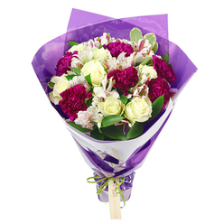 The image presents a luxurious, hand-crafted bouquet that feels both modern and timeless, like a thoughtful gift arriving at a doorstep near Epping Forest on a bright morning. The top of the arrangement is packed with blossoms, creating a perfectly rounded, almost cloud-like shape where creamy white roses nestle against deep magenta carnations. The roses have a classic, romantic form, their petals unfurling in tight, symmetrical spirals, while the carnations contribute frilled, abundant layers that deepen the overall texture and richness. Slender stems of white alstroemeria weave between them, each bloom marked with soft pink streaks and tiny freckles that draw the eye inward to their darker stamens, echoing the richer berry tones around them. Fresh green leaves, some with subtle variegated edges, frame the flowers and add a natural lift, as if the bouquet has just been gathered from a well-tended garden off Epping High Street. The florist has wrapped the stems in a crisp inner layer of white paper, which forms a neat collar around the heads, then finished the piece with a translucent purple outer wrap that ripples gently and reflects light in delicate highlights. A shiny, iridescent green satin ribbon is cinched tightly at the base, tied into a neat bow from which a small, rectangular kraft tag dangles, ready for a handwritten message. The bouquet radiates a feeling of thoughtful celebration and tender care, making it easy to imagine it being sent through a local Epping flower delivery service to mark a promotion, a milestone birthday, or a simple "thinking of you" for someone in a quiet lane near Theydon Bois.