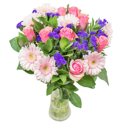 As I arrange each bloom in this Epping-inspired bouquet, I'm drawn to the gentle interplay of blush-pink gerberas and classic roses that evoke the tranquil elegance of our local gardens. Their soft shades meld as if dusted in early spring light, while vivid violet statice peeks through, bringing a cheerful rhythm and textural spark. There's a palpable freshness in the glossy leaves below-their verdant green reminds me of the open fields just beyond Epping's bustling High Street, cool to the touch and rich with possibility. The entire composition feels luminous, suffused with optimism and the promise of brighter days, reminiscent of morning strolls through Epping's leafy lanes. Arranged in a simple, clear glass vase, the bouquet glows quietly, inviting admiration without demanding attention. Whether sent as a heartfelt get-well gesture or a stylish complement to an Epping living room, each stem reflects the wholehearted craft and attention of local florists, designed to share a moment of joy and gentle care with friends, family, or neighbours close to home.