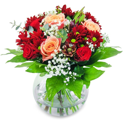 Cradled in your hands, this enchanting bouquet radiates the soft, romantic light of Epping's early mornings-a cascade of plush crimson chrysanthemums, rich red roses, and apricot-hued blooms, all tenderly arranged by local florists for moments of shared emotion. White gypsophila floats between the bold flowers, much like delicate clouds above Bell Common, infusing a sense of celebration and springtime promise. Subtle peach roses add a mellow, sun-drenched warmth, tempering deep reds with a gentle glow reminiscent of the pastel skies at the fringes of Epping Forest. The bouquet is anchored by vibrant greenery, its earthy aroma conjuring the nearby trails and gardens. Each sturdy stem sits in clear water, revealing the bouquet's freshness and honest craftsmanship-a hallmark of Epping's trusted floral traditions. Lifting this arrangement brings the faint, sweet perfume of roses, mingled with green notes, offering an invigorating pick-me-up or a heartfelt congratulations. Perfect as an elegant centrepiece for birthdays, intimate dinners, or marking a special day in Epping, this thoughtfully balanced bouquet reflects the enduring joy and quiet sophistication at the heart of the local community.