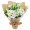A fresh, hand-gathered bouquet of white blooms stands upright against a clean white background, its calm, understated beauty immediately apparent. At the heart of the arrangement is a generous cluster of bright white, daisy-like chrysanthemums: each head full of fine, radiating petals surrounding a soft yellow centre that lends a gentle cheerfulness to the composition. Threaded among these are several elongated lily stems with pale green-yellow buds, some lightly striped and tightly closed, others beginning to unfurl their smooth petals - a poised sense of anticipation that promises further bloom over the next few days. Sprays of airy white baby's breath (Gypsophila) float between the larger flowers like soft clouds, their tiny blossoms adding a lace-like texture that mellows the stronger shapes. Deep, glossy green foliage frames the blooms, giving weight and a verdant contrast that makes the whites read even crisper in the soft, diffuse studio light. The bouquet is wrapped in a tactile double layer: an inner sheet of crinkled brown kraft paper lending an earthy, village-shop feel, and an outer glossy cellophane that protects and brightens the stems while letting the flowers show through. The papers are gathered and tied at the base to form a neat, portable stand - the sort of hand-tie a local florist would knuckle and fold to ensure the stems sit securely. The scent is clean and faintly green, like early morning grass after rain. This arrangement - white chrysanthemums, unopened striped lilies and wispy gypsophila - reads as pure and consoling, suited to quiet celebrations, a thoughtful thank-you, or a gentle expression of sympathy; it's the kind of bouquet someone might pick up on a walk from Epping High Street toward the edge of Epping Forest.