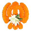 A meticulously crafted floral Khanda fills the frame against a clean white backdrop, its classical components rendered entirely from tiny, tightly clustered bright orange marigold heads. The chakkar's round sweep and the two crossed kirpans behind it read clearly in dense, velvety orange texture, while a smaller upright khanda is suggested at the centre by a subtly raised line of blooms-the whole formation catching soft studio light to reveal a gentle sheen and three-dimensional depth. Nestled exactly where the kirpans intersect, a small bouquet of pristine white lilies offers a cooling focal point: at least two fully open lilies with softly curving petals, pale green-and-yellow stamens, and several smaller buds ready to unfurl. Around the lilies, sprays of tiny white filler flowers and glossy green foliage-pointed salal-like leaves-frame the centre, introducing fresh scent and a verdant counterpoint to the celebratory orange. A faint shadow beneath the piece hints that this is a freestanding or tray-mounted tribute rather than a flat appliqué. The overall mood is reverent and warm, a floral emblem that reads as both devotional offering and decorative craft, suitable for Sikh festivals, remembrance, or temple adornment. As a local florist I imagine this piece placed beneath the dappled light of Epping Forest on Vaisakhi morning, or displayed respectfully in a community space off Epping High Street; the combination of marigold warmth and lily calm speaks of devotion, unity, and quiet celebration, conveyed with careful floral technique and an eye for texture and balance.