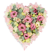 A large, heart-shaped floral tribute is shown from above, resting on a crisp white background that allows its soft colours and details to stand out. The heart is outlined with a slim band of pale pink satin ribbon, its gentle shine tracing every curve and ending in small, elegant bows at the upper bend and the pointed base, giving the design a polished, handcrafted finish. Inside this frame, the flowers are tightly packed, creating a lush, almost cushion-like feel. Ruffled pink lisianthus, in shades from soft rose to slightly deeper blush, are layered with frilly pale pink carnations, their petal edges crimped and full, giving a sense of depth and richness. Dotted between them are clusters of creamy ivory and buttery yellow spray roses, or similar small roses, their rounded forms and unfolding petals introducing warmth and subtle light. Tiny, white, daisy-style flowers with clear yellow centres are scattered throughout like little stars, adding a playful yet tender note, reminiscent of wildflowers growing along paths near Epping Forest or by the fields on the way to Thornwood. Soft, silvery eucalyptus with its rounded leaves winds gently among the blossoms, accompanied by darker green, variegated foliage that peeks through to provide contrast and a natural, garden-like structure. The overall impression is of a carefully considered, deeply loving tribute. This heart would be fitting for a funeral service, cremation, or memorial gathering arranged in and around Epping, offering bereaved families a visible symbol of compassion, remembrance, and enduring affection crafted with the sensitivity of a skilled local florist.