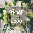 Set in the soft, lucid morning light of Epping, this luxurious Florist Choice bouquet pairs large white lilies with vibrant lime-green clusters to form a contemporary classic. The lilies dominate, their broad petals unfurling with a satin glow, while around them, smaller white blooms-ranunculus or spray roses-open in plush, cloudlike swathes that catch the eye and invite a closer look. The lime greens-dense, textured heads of Green Trick dianthus or compact hydrangea-punctuate the bouquet, giving it an energizing, modern edge and highlighting the contrast against deep, forest-green leaves of eucalyptus or ruscus. The arrangement feels sophisticated yet accessible, a signature blend that suits grand occasions or intimate celebrations alike. The bouquet is held by a figure in light, almost ethereal attire, hinting at a wedding or formal event, while the background remains pleasantly blurred to keep attention on the florals. In the center, a crisp white frame carries the brand's presentation: Florist Choice at the top in a flowing script, BOUQUET in uppercase beneath, and a bold ?200 at the bottom, signaling premium value. Flowers Epping is proud to offer this ready-to-order design with options for same-day delivery across Epping and nearby neighbourhoods such as Loughton, Chigwell, and Debden, ensuring freshness and skilled craftsmanship travel with every delivery.