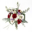 There's a harmonious celebration captured in this bouquet, artfully assembled by Epping's talented florists and bathed in soft, natural light as if reflecting the gentle mornings over Epping Forest. The centerpiece-deep red velvety roses-radiates passion and grace, their petals unfurling in tightly held spirals that evoke heartfelt devotion. Surrounding these, crisp white gerbera daisies with chocolate-brown centers offer a luminous, cheerful counterbalance, while feathery spray chrysanthemums, in subtle white tones, provide fluffy softness and airy movement. Slender sprays of silvery eucalyptus arch around the blooms, lending a sophisticated wildness and a subtly refreshing scent that brings to mind breezy walks along Bell Common or the open spaces of nearby parks. Lilac lisianthus peek softly from between the bolder blooms, their bell-shaped petals introducing a cool, calming note-a reminder of tranquil outdoor gatherings in the Epping area. Every element feels deliberately chosen and gently placed, resulting in a bouquet that exudes thoughtful care and elegant abundance. Ready for same-day delivery throughout Epping, it would grace any occasion-from winter anniversaries to cozy gatherings at home-radiating comfort, vibrance, and the beauty of local craftsmanship.