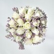 This exquisite bouquet effortlessly captures the tranquil charm of Epping on a peaceful morning. Crisp, plush white roses form the heart of the design, their creamy petals unfolding in gentle, spiral whorls-each a celebration of new beginnings and quiet confidences cherished within the local community. Threaded gracefully between them, slender sprays of pale lavender statice lend a delicate, lace-like texture, their subtle shimmer reminiscent of the soft mist often seen above Epping's gardens at dawn. Subtle touches of green foliage emerge here and there, providing a fresh contrast and suggesting the lush beauty of nearby forest trails. The soft wash of natural light makes every bloom appear luminously fresh, creating a composition that radiates calm, grace, and understated joy. Crafted with loving attention to detail, this bouquet brings a sense of heartfelt comfort or serene celebration-an offering of purity and hope, ideal for conveying congratulations, sympathy, or simply brightening a treasured home along Epping High Street. The feeling lingers, like the faint scent of roses drifting through an open window on a sunlit day in Epping.