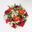 Brimming with colour, texture, and exuberant charm, this bouquet is a true celebration of joyful moments, embodying the cheerful spirit of Epping. Dazzling orange gerberas radiate from the heart, their vivid petals seeming to catch every glint of daylight, just as wildflower meadows capture the morning sun near Epping station. Nestled among them, plush magenta carnations and delicate blush roses create a luxurious mix of soft, velvety textures-so inviting that one can almost imagine sinking into their petals. Snowy white alstroemeria and tiny daisy-esque blooms add sparkling highlights, as if a fresh layer of dew has kissed each flower at dawn. Glossy, abundant greenery frames the design without overpowering it, echoing the lush woodlands and hedgerows at the town's edge. The harmonious palette brings together warmth and optimism, artfully woven with the expertise of local hands. Whether delivered for a birthday, a celebration at a High Road café, or simply to brighten a day, this bouquet offers not only vibrant beauty but a gentle fragrance that hints at new beginnings-a reminder of why Epping's florists are cherished throughout the community.