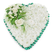 White chrysanthemum heart tribute designed as a tender floral symbol of remembrance, suitable for funerals and memorials across Epping. The heart shape is completely filled with tightly packed white chrysanthemums, their rounded, multi-petalled heads creating a thick, cushioned surface that evokes softness and repose. Each stem has been carefully placed so the blooms touch and overlap, leaving no visible gaps, forming a snowy expanse of floral texture that radiates calm. Encircling the heart is a pleated emerald green satin ribbon, folded into even, decorative ruffles that produce a defined, scalloped outline. The ribbon's rich colour and satin sheen provide a tasteful contrast to the matte white petals, lending the design a polished, traditional character often favoured for services in local churches and chapels. In the upper left section, a thoughtfully arranged accent spray adds focus: a small group of open white roses, their petals gently curled, sits amidst finer white flowers such as freesias or similar petite blossoms, some still in bud. Deep green foliage-broad leaves combined with lighter, airy fronds-cradles the roses, some pieces delicately extending outwards and trailing over the chrysanthemum base, giving the tribute a sense of movement and natural grace. Set against a plain white background, the heart stands out clearly, its form and details easy to imagine even without sight. This arrangement, crafted in the style local families in Epping often request, offers a quiet, respectful way to say goodbye, expressing affection, sympathy, and lasting remembrance during times of loss.