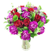 A lush, rounded bouquet of deep crimson roses and vivid magenta-purple carnations sits in a simple clear glass vase, set against a bright white backdrop. The roses range from tight spiral buds to gently unfurling blooms, their velvety petals catching a soft, diffused light that highlights the rich, romantic red. Interspersed are plentiful ruffled carnations whose frilly, almost fuchsia-tinged purple petals add playful texture and a lively contrast to the smoother rose surfaces. Fresh, glossy green foliage - the broad, shining leaves of ruscus or similar greens - fills the arrangement, creating a cool emerald cushion that makes the reds and purples sing. Slender sprigs of silvery-green eucalyptus thread through the bouquet, bringing a modern air and a faint, clean aroma that would lift the overall scent when the arrangement is handled. The stems are visible through the transparent vase, neatly trimmed and gathered to form a dense, full silhouette that reads as generous and celebratory. The composition feels both classic and contemporary: romantic without being fussy, exuberant yet composed. This piece reads as a thoughtful gift for an anniversary or Valentine's Day, or as a bright, encouraging delivery to mark a birthday, promotion, or heartfelt 'thank you.' As a local florist in Epping I often picture this design gracing a small table near the High Street, placed beside a coffee from a nearby café or left at the gates of Epping Forest to surprise a loved one. The overall impression is of freshness, careful craft, and confident colour-a bouquet that looks refined in the white studio light and warmly alive in someone's home.