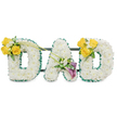 A tender, three-dimensional memorial spelling out DAD in large, freestanding block letters, each formed from a dense, pillowy carpet of pristine white spray chrysanthemums that give the letters a soft, cloud-like texture. The outer and inner contours are crisply defined with a ruffled, deep emerald satin ribbon that reads like a dark green frame against the white blooms, while slim, dark green metal support bars run horizontally behind the letters, holding the composition together with quiet strength. The left D is accented on its upper left curve with a cheerful cluster of three to four sunlit yellow roses, their petals open and warm, set among tiny white filler blooms such as freesias or gypsophila and fresh, glossy foliage; two long, graceful green stems arch diagonally across toward the centre, adding movement. The central A carries an elegant accent on its lower diagonal: two sculptural, deep purple-burgundy calla lilies whose trumpet shapes draw the eye inward, surrounded by delicate white sprays and soft greenery. The right D mirrors the left with a matching cluster of bright yellow roses and airy white accents, creating symmetrical balance and a feeling of care. Presented against a clean white background and finished with subtle foliage tendrils, the piece smells faintly of fresh greens and citrus-tinged roses, a restrained, comforting scent. Crafted with careful mechanics and floral technique, this arrangement is a dignified sympathy tribute - a peaceful visual message of love and remembrance suitable for services in and around Epping, quietly evoking the calm of Epping Forest and the reassurance of local care during times of loss.
