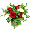 This photograph shows a sophisticated floral arrangement of red roses and white calla lilies, artfully styled in a clear glass vase so that the flowers appear to float above a column of neat green stems. The bouquet is generous and rounded, with six or seven red roses opening fully at the centre. Their petals, thick and velvety, spiral inward in rich crimson layers, each bloom carrying that unmistakable sense of passion and timeless romance. Rising between them are four or five white calla lilies, their tall, trumpet-shaped forms adding a graceful vertical line. The lilies' petals are creamy and smooth, almost wax-like in their sheen, curling back to reveal a contrasting yellow spadix that brings a soft warmth to the cool white. Surrounding this red-and-white duet, a collar of greenery adds volume and gentle movement: eucalyptus sprigs with slender, slightly rounded leaves create a feathery halo in soft silvery-green, while deeper emerald foliage offers a glossy, substantial backdrop that makes the blooms stand out more vividly. The cylindrical vase, resting on an unseen surface, is simple and modern, its subtle ribbed base providing just a hint of texture as it catches the bright, even light. Set against a perfectly white background, the composition feels clean, contemporary, and elegant-as suitable for a romantic delivery to a townhouse near Epping High Street as for a thoughtful anniversary surprise in a home overlooking Epping Forest. The overall impression is of quiet luxury and heartfelt sentiment, the kind of bouquet chosen when someone wants their flowers to speak clearly of love and appreciation.