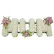 A solemn, three-dimensional funeral tribute spells the word MOM in bold capital letters, each letter densely cloaked in snowy white spray chrysanthemums that create a soft, cloud-like surface. Under gentle studio lighting the tiny petals read as plush texture and pristine white, conveying purity and quiet reverence. At the upper left curve of the left 'M' a tasteful cluster of soft pink and pale lavender roses drifts into view, their velvety petals partly open and partly in tight bud, releasing a faint, sweet rose scent that softly balances the cool chrysanthemum note. The central 'O' is anchored by a smaller, matching bouquet tucked at its base, while the right 'M' carries a mirror cluster on its upper right arm - each cluster framed by fresh green leaves and slender fern fronds that add liveliness and depth against the white. A dark green structural band - a ribbon-wrapped frame or moss-covered foam base - peeks along the bottoms of the letters, a subtle outline that holds the shapes together without distracting from the blooms. The arrangement sits against a brilliant white background, which sharpens the colours and gives the piece a calm, luminous presence suitable for a chapel, funeral parlor, or graveside. The overall feeling is one of tender remembrance: crisp white for peace, blush and lavender for personal affection, and the textured greenery to suggest life and continuity. Crafted with traditional sympathy sensibility, this bespoke MOM tribute would be fitting for a mother's service in Epping or nearby Loughton, easily described to a loved one who needs to picture the comfort and care of the design.
