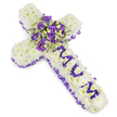 A solemn, hand-crafted funeral cross composed of a dense carpet of soft white chrysanthemums sits against a clean white backdrop, the light catching the pillowy texture of each floret to create a feeling of calm and purity. The body of the cross has been fashioned with meticulous care so that every chrysanthemum head nestles closely to its neighbour, producing a cloud-like surface that reads as both gentle and enduring. Along the outer edge a ruffled purple satin ribbon is woven with deliberate grace, its deep lilac folds framing the shape and lending a refined, slightly vintage dignity to the composition.

At the centre, where the arms meet, a lush spray becomes the visual heart: deep violet and lavender roses mingle with pale purple lisianthus (eustoma), their layered petals offering velvet depth and a quiet, enveloping beauty. Variegated green foliage-leaves edged in lighter lime and graced with darker centres-adds crisp texture and a sense of natural renewal, while small round green berries punctuate the cluster with subtle contrast. Running down the vertical arm, the word MUM is formed from smaller purple flower heads, the letters clearly defined against the white chrysanthemum field and conveying an intimate, personal tribute.

The overall palette of pristine white and layered purples-from soft lavender to near-indigo-evokes serenity, respect and tender sorrow. There is a faint, powdery floral scent suggested by the blooms, like a quiet spring morning after rain. This arrangement, shaped for memorial use, reads as a dignified expression of love and remembrance, appropriate for a funeral service or graveside tribute, and crafted to offer comfort when words are scarce.