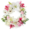 Against a pristine white background, this open circular sympathy wreath appears as a calm, flowing ring of white, pink, and magenta blooms, lovingly arranged with the careful touch of a local Epping florist. Large white lilies, some fully open and others just beginning to unfurl, anchor the design; their expansive petals and golden-tipped stamens radiate a feeling of peace and spiritual grace. Intermixed among them are striking fuchsia and deep pink lilies, their vivid colour and fine speckling drawing the eye around the circle and adding warmth to the composition. Tucked between the lilies are numerous white gerbera daisies, each with a dark, defined centre and a halo of slender petals, bringing both texture and a gentle brightness. Soft pink roses, many in bud or semi-open bloom, offer a quiet, romantic softness, while creamy white roses, fuller and more layered, lend an air of timeless dignity. Smaller white filler flowers, such as spray carnations or tiny chrysanthemum-style blooms, are woven throughout to create a densely packed, seamless ring with no stark gaps. A rich base of mixed green foliage supports the flowers, with leaves in different sizes and shades of green adding depth and framing the overall circle. The wreath feels serene and contemplative, perfectly suited to rest beside a coffin in an Epping chapel, accompany a graveside service, or be delivered to a home near Bell Common, expressing condolences, respect, and the enduring circle of love and memory.