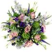 Captured from directly above, this bouquet forms a generous, rounded cluster of flowers, almost like a living tapestry laid out on a white canvas in the heart of Epping. The most prominent notes are the roses: large, fully opened blossoms in soft blush, dusty mauve, and muted rose-pink, each bloom composed of gently curling petals that spiral inward to a tender centre. Between these romantic focal flowers, delicate sprays of lavender-toned aster-like blooms appear, their slim petals encircling bright yellow centres that sparkle against the cooler purple shades. Deep, velvety lisianthus flowers in shades of rich violet and indigo are threaded throughout, their softly frilled, bell-shaped petals adding depth and a touch of evening drama. Vertical accents come from the slender stalks of Veronica, densely packed with tiny purple flowers that draw the eye upward within the composition, conveying movement and energy. Scattered among the petals are distinctive round tufts of bright, chartreuse green, likely Green Trick dianthus, whose dense, moss-like texture offers a playful counterpoint to the bouquet's otherwise silky surfaces. Surrounding and weaving through the flowers are stems of eucalyptus, their silvery-green, slightly rounded leaves casting a cool, calming tone that suggests a gentle, refreshing fragrance. Extra greenery fills any remaining gaps, giving the bouquet a full, lush, and carefully finished look. The overall effect is joyful yet refined-an arrangement that feels equally suited to brightening a home near Epping Forest or marking a milestone celebration, delivered fresh to doors across the Epping area by skilled local florists who understand how to balance colour, texture, and emotion.