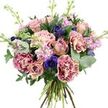 A lavish, dome-shaped bouquet fills the frame against a crisp white background, its colours and textures carefully balanced to create a sense of calm luxury. At its core are several roses in muted dusty pink and soft peach, some open enough to reveal their spiralling hearts, others still partly closed, their outer petals wrapping protectively around the centre. Surrounding them, ruffled carnations show off a distinctive two-tone pattern, their outer edges glowing with rich magenta that gradually softens into pale blush nearer the middle, adding layers of interest and fullness. Dotted through the pastel flowers are deep indigo and violet-blue anemones, each one with a dark, almost black centre that draws the eye and introduces a more dramatic note, much like the inky shadows you see under the trees around Epping Station at dusk. Slender spires of lavender and pale pink stock rise lightly above and between the larger blooms, their many small florets forming soft, frothy plumes that suggest a gently perfumed breeze. A collar of greenery frames the entire arrangement, with rounded, silvery eucalyptus leaves and deeper green foliage providing contrast and structure, echoing the mix of wild and cultivated plants in gardens across Epping. The stems are neatly bundled at the base, clearly hand-tied, ready to be delivered and slipped straight into a vase on a dining table or office desk. Lit with bright, even light, every petal, leaf vein, and colour nuance is visible, giving the bouquet a poised yet welcoming feel, perfect for celebrating a birthday, expressing quiet affection, or brightening a home near Epping High Street or the surrounding villages.