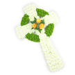 Viewed from a gentle overhead angle against a bright white backdrop, this is a three-dimensional Celtic cross formed entirely from fresh flowers - a composed memorial that reads both solemn and hopeful. The primary structure is densely covered in small, pure white spray chrysanthemums whose cloud-like heads create a soft, dignified surface across the arms and extended lower shaft. Woven through that white plushness are vivid apple-green button chrysanthemums, their rounded, tightly packed forms tracing the circular ring where the arms meet and appearing in alternating segments along the horizontal arms to suggest a classic Celtic knot. At the very centre, where the circle and arms converge, three lush orange-yellow roses form a warm focal cluster; their buttery, golden-petalled blooms seem to glow against the cool white and fresh green, and are gently framed by deep green ferny sprigs that add contrast and an evergreen depth. The lighting is clear and even, the petals crisp with soft highlights that show texture, while the overall palette - white, lime-green and orange-yellow - quietly echoes Irish colours, making this suitable for a remembrance that honours Celtic heritage. As a local florist familiar with Epping and the neighbouring villages, I imagine this piece laid with care at a service near St. John's Road or beneath the dappled shade of Epping Forest, carrying a subtle scent of chrysanthemum and rose. It is an arrangement designed to convey respectful condolence and enduring memory, a tactile symbol of faith and family that reads with quiet clarity from every angle.