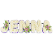 A tender, hand-crafted memorial spelling JENNA in large, three-dimensional capital letters, photographed against a clean white backdrop that highlights every soft detail. Each letter is densely packed with small, creamy white chrysanthemums (or similar petite florets), the close-set blooms forming a cloud-like surface that reads both timeless and reverent. A slim band of deep purple trim traces the inner edges of each letter, providing subtle definition and a calm contrast to the pristine white flowers. Delicate accent clusters - composed of blush-pink and lavender spray roses, a few cream or pale yellow roses, and sprigs of dark green fern - sit thoughtfully on the J, on one of the N letters, and on the concluding A, bringing gentle warmth and dimensional movement to the composition. Thin, dark supporting bars run horizontally behind the base of the word, discreetly joining the letters into a stable display suitable for standing at a chapel or crematorium. The arrangement carries a quiet scent of fresh chrysanthemums and roses, and the soft studio light falls across the petals to create a gentle sheen that suggests both memory and grace. As a sympathy tribute, this floral name piece reads as a personal, dignified farewell, designed to sit beside a coffin or to lead the floral display at a celebration of life. A local florist's hand is evident in the even spacing, the firmness of the structure, and the restrained use of colour - choices that soothe rather than overwhelm. The overall mood is one of respectful beauty, an intimate gesture of name and remembrance suited to services in Epping or nearby chapels.