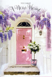 A sunlit doorway in Epping is lovingly dressed for a new beginning, with a pale pink door at its heart quietly reflecting the soft afternoon glow. Above and around it, wisteria unfurls in sweeping lavender cascades, each bloom a delicate cluster that hangs like a curtain of petals against the smooth, whitewashed wall. The matching blush shutter sits slightly ajar, adding a casual, lived-in charm, reminiscent of the characterful homes dotted along the roads leading towards Epping Forest. On the doorstep, a simple grey metal bucket becomes something special in the hands of a skilled florist: it spills over with lush white and cream roses, their velvety petals layered in gentle spirals, framed by sprigs of muted green foliage. A soft pink ribbon encircles the bucket, tied in a loose, elegant bow that echoes the pastel tones of the scene, its satin sheen catching the light just enough to draw the eye. The overall palette is a symphony of blush, ivory, and lavender, with sunlight creating gentle shadows that add depth without disturbing the calm. You can almost inhale the mingled scent of wisteria and freshly cut roses, that light, sweet fragrance that feels perfect for a spring or early summer day. The scene feels intimate and personal, as though the flowers have just been delivered to celebrate someone's move to a new home in Epping or nearby Theydon Mount, ready to greet them when they arrive at the door. It's a quietly joyful composition, ideal for marking milestones, offering congratulations, or simply saying, with flowers, that this place is already cherished.